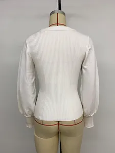 Detailed back view showing the fine ribbed texture and slim fit of the white knit sweater