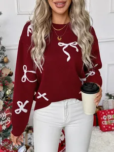 Detail of red bow jacquard knit sweater with ribbed cuffs in a festive holiday setting