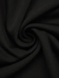 Macro shot of black knitted fabric texture showing soft drape and fine elastic weave