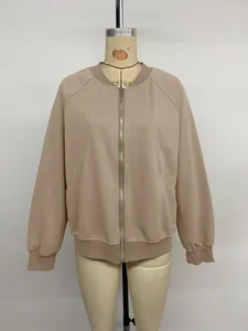 Detail of khaki zip-up jacket with metal zipper, stand collar and ribbed cuffs