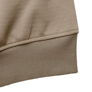 Macro detail of ribbed cuffs and fine stitching on a casual brown knit jacket