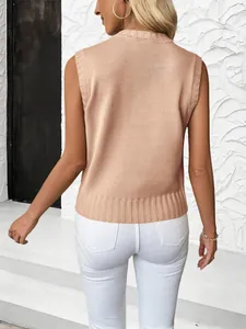 Detailed back view of pink knit vest featuring classic cable texture and ribbed hems