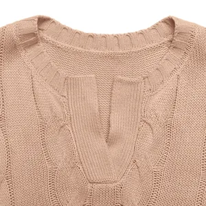 Detailed macro view of pink cable knit sweater vest with ribbed V-notch neckline