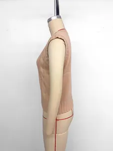 Detailed side view of light pink cable knit sweater vest with thick textured braiding