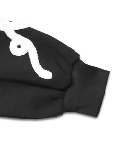 Detail of ribbed cuff and high-quality white towel embroidery on black fleece sweatshirt