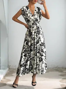 Detail shot of the deep V-neck and black floral print on the white summer dress