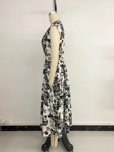 Detail of V-neckline and vintage black floral print on white sleeveless midi dress