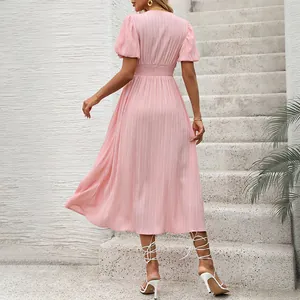 Elegant pink midi dress with puff sleeves, V-neck and smocked waist shown from back view