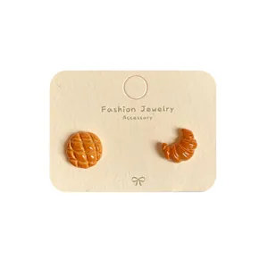 Orecchini a perno a forma di pane al caramello con mini croissant e forme di melon pan
