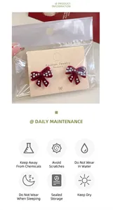 Detail of red flocked bow earrings with pearls in protective card packaging