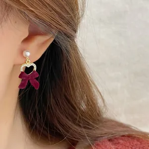 Elegant wine red velvet bow earrings with gold heart frame and pearl drop detail