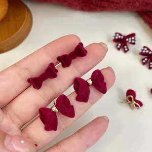 Elegant burgundy velvet bow earrings for women with soft texture and golden metal accents