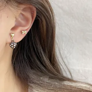 Sweet red polka dot heart earrings and gold bow stud set for a stylish feminine look