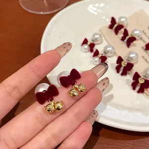 Elegant wine red velvet bow earrings with white pearls and festive gold bells for women