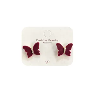 Elegant wine red velvet bow earrings with pearls and crystals on white display card