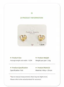 Detail view of silver heart earrings with gold inlay and zircon, measuring 1.5 cm
