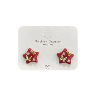 Red heart-shaped stud earrings with gold butterfly accent and sparkling crystals