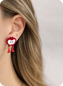Detail of red heart earring with cute boot charms shown on model for New Year