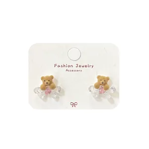 Brown flocked teddy bear stud earrings with pink heart zircon and bow detail