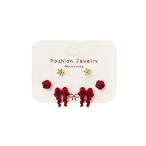 Three-pair red velvet bow and rose stud earring set with gold floral accents