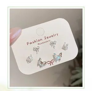 Close-up of a 6-piece silver butterfly stud earring set with iridescent crystals