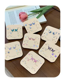 Detailed view of the 7-pair weekly earring set with butterflies and floral designs