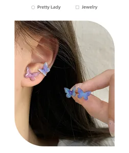 Detailed view of butterfly stud earrings in gradient pink and blue purple tones