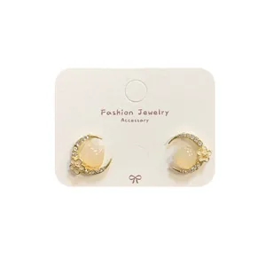 Pink cherry blossom moon earrings with cat motif and sparkling crystal accents