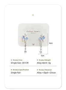 Detail view of long tassel earrings with cat's eye stone butterflies and size parameters