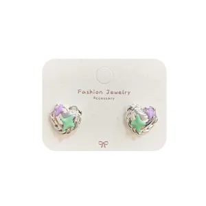 Minimalist heart stud earrings with purple and green star patterns on silver base