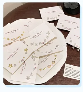 Assorted gold stud earring sets with star heart and butterfly designs on display