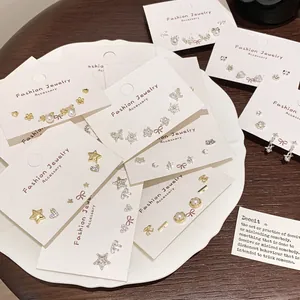 Three-pair minimalist earring set featuring stars, butterflies, and pearls in gold and silver