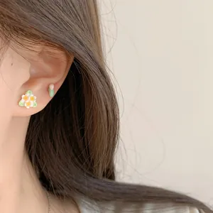Floral stud earrings set featuring white flowers with yellow centers and green leaf accents