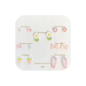 Set of 7 pairs cute floral and heart stud earrings for women on a weekly display card
