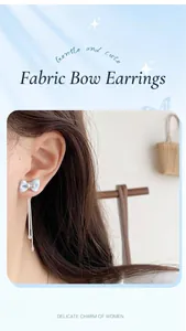 Close-up of light blue fabric bow earrings with silver tassel fringe and rhinestones