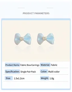 Detail view of light blue satin bow earrings with silver heart center and size specs