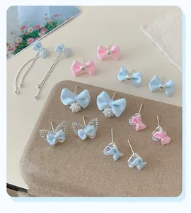 Collection of light blue and pink fabric bow earrings with pearls and crystals