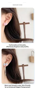 Detailed view of pink ribbon bow earrings and blue long tassel chain drop ear jewelry
