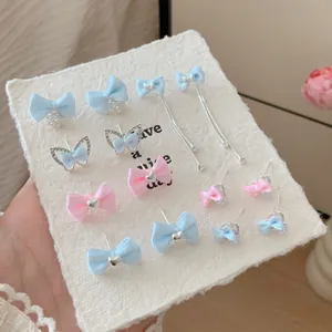 Sweet fabric bow earrings set with pearls and zircons in light blue and pink pastel colors