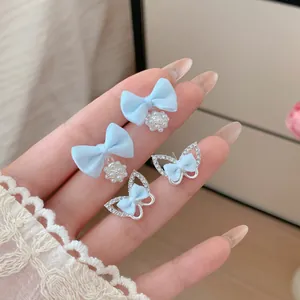 Sweet light blue fabric bow and silver butterfly earrings set with pearls and rhinestones