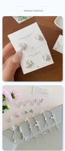 Detail of colorful gradient butterfly tassel earrings with pearls in dreamy pastel tones