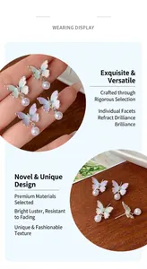 Detailed macro view of butterfly drop earrings with gradient oil drip and white pearl tassels