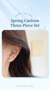 Detail shot of cute cartoon girl and planet earrings from the three-piece fruit set