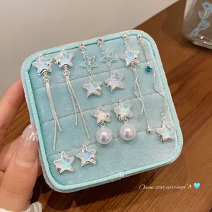 Sparkling silver ocean star earrings set with pearls in a blue velvet jewelry box