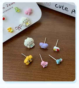 Close-up of cute cartoon resin stud earrings set including heart and bow shapes