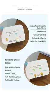 Detailed view of colorful cartoon fruit and animal stud earrings on a display card