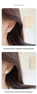 Close-up of cute cartoon girl and rabbit stud earrings with drip oil finish
