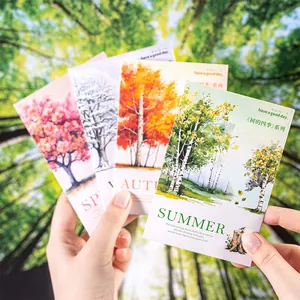 Set of four seasonal tree postcards with artistic hand-drawn nature illustrations