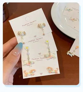 Detail view of colorful cartoon dachshund dog earrings with faux pearl and crystal accents