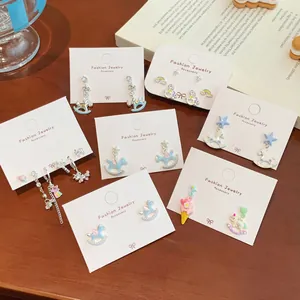 Whimsical colorful enamel unicorn and carousel drop earrings with pastel heart accents